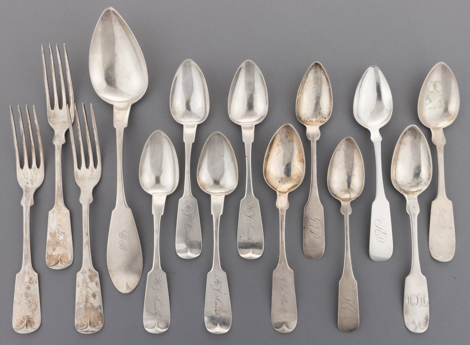 NEW YORK AND CONNECTICUT COIN SILVER SPOONS AND FORKS, LOT OF 14: NEW YORK AND CONNECTICUT COIN SILVER SPOONS AND FORKS, LOT OF 14, each piece having a fiddle handle with pointed shoulders and a personalized engraving; comprising three pieces by / retailed by Hender
