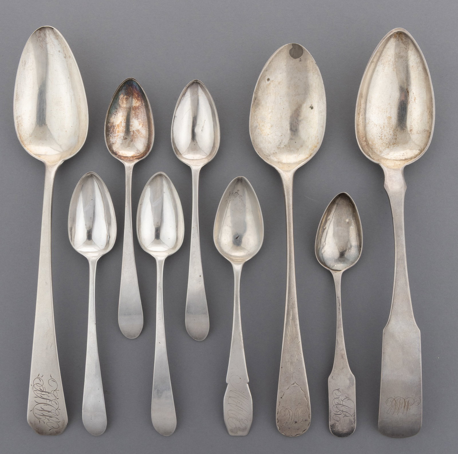 PENNSYLVANIA, NEW YORK, AND POSSIBLY OTHER COIN SILVER SPOONS, LOT OF NINE: PENNSYLVANIA, NEW YORK, AND POSSIBLY OTHER COIN SILVER SPOONS, LOT OF NINE, comprising a set of four teaspoons by James Black of Philadelphia, PA (active 1795-1821) with backwards-tipped taped handles