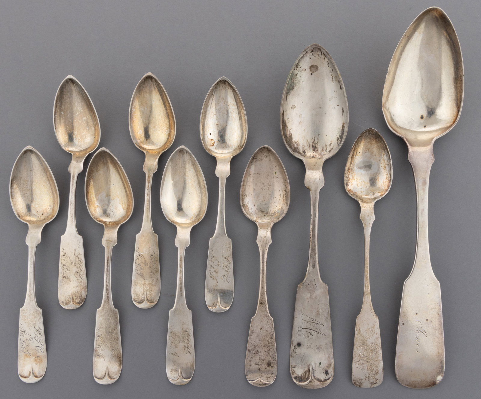 PENNSYLVANIA COIN SILVER SPOONS, LOT OF TEN: PENNSYLVANIA COIN SILVER SPOONS, LOT OF TEN, each piece having a pointed oval bowl on a fiddle handle with pointed shoulders and a personalized engraving; comprising seven pieces by Isaac Garrison of 