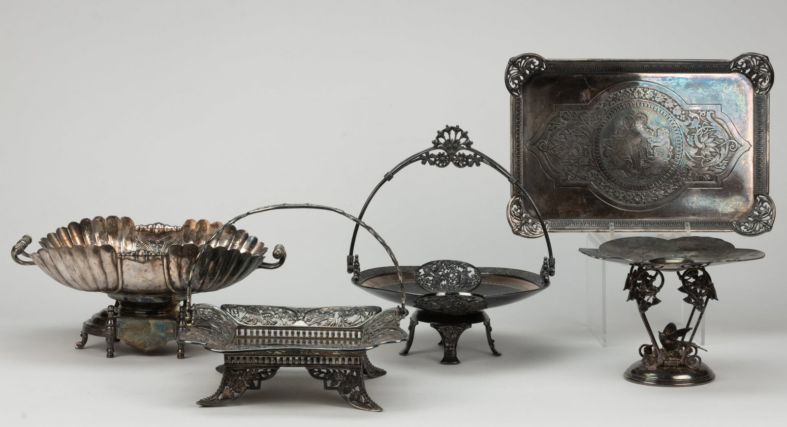 PAIRPOINT AND OTHER SILVER-PLATED ARTICLES, LOT OF FIVE: PAIRPOINT AND OTHER SILVER-PLATED ARTICLES, LOT OF FIVE, each Aesthetic Movement, or in the style of; comprising a no. 1230 square-form basket by Pairpoint Mfg. Co. of New Bedford, MA (active