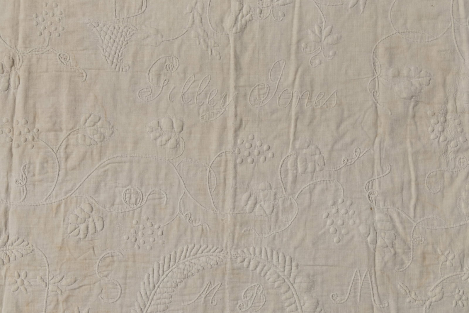 AMERICAN, POSSIBLY VIRGINIA, TRAPUNTO WHITEWORK QUILT: AMERICAN, POSSIBLY VIRGINIA, TRAPUNTO WHITEWORK QUILT, hand-stitched, top with two joined panels having quilted and stuffed / corded designs, featuring stylized flowers and cornucopias with hearts to 