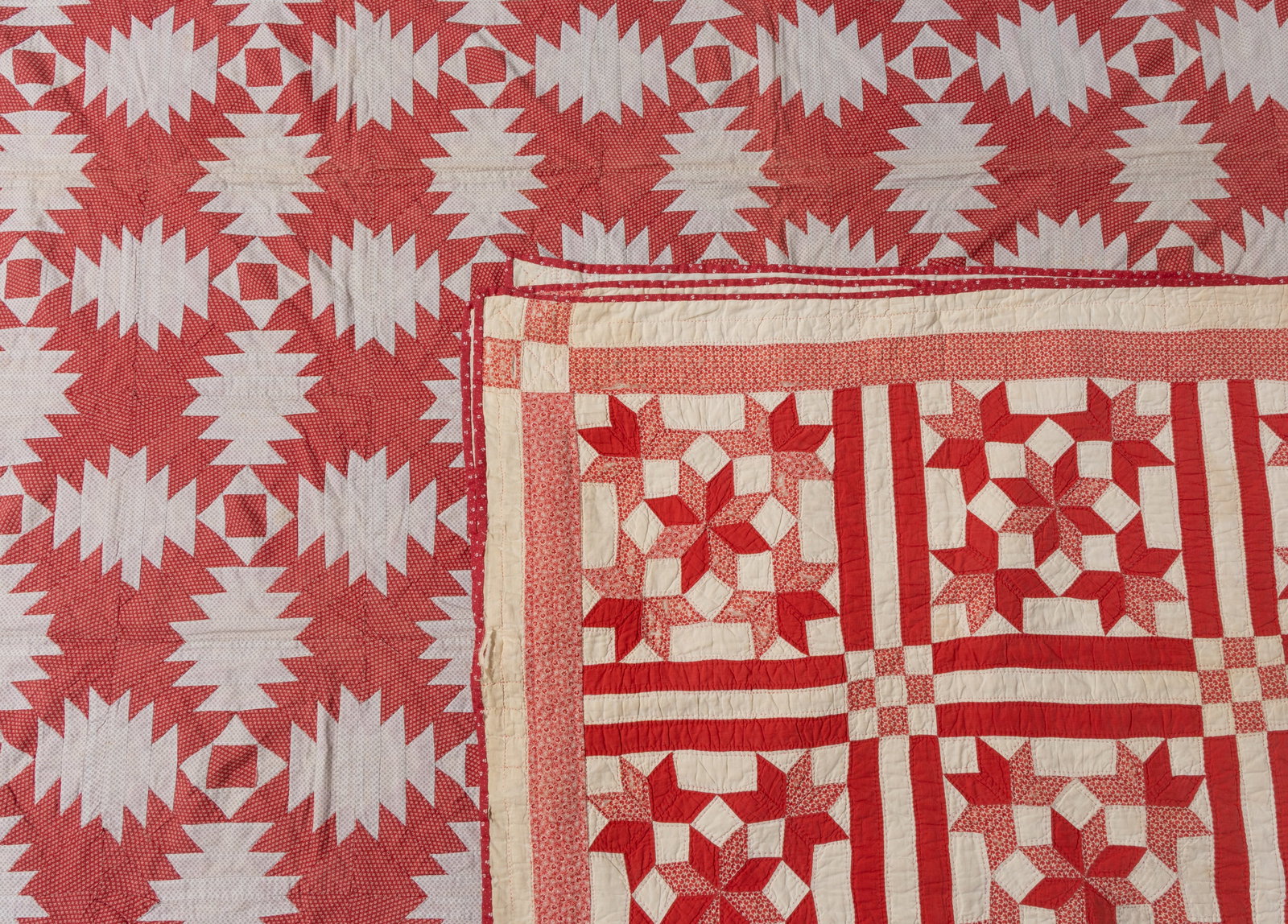 AMERICAN PIECED QUILTS, LOT OF TWO: AMERICAN PIECED QUILTS, LOT OF TWO, each hand-stitched, having later-applied fabric strip for hanging along one edge of backing; comprising a "Pineapple" quilt, 56 whole and eight half block