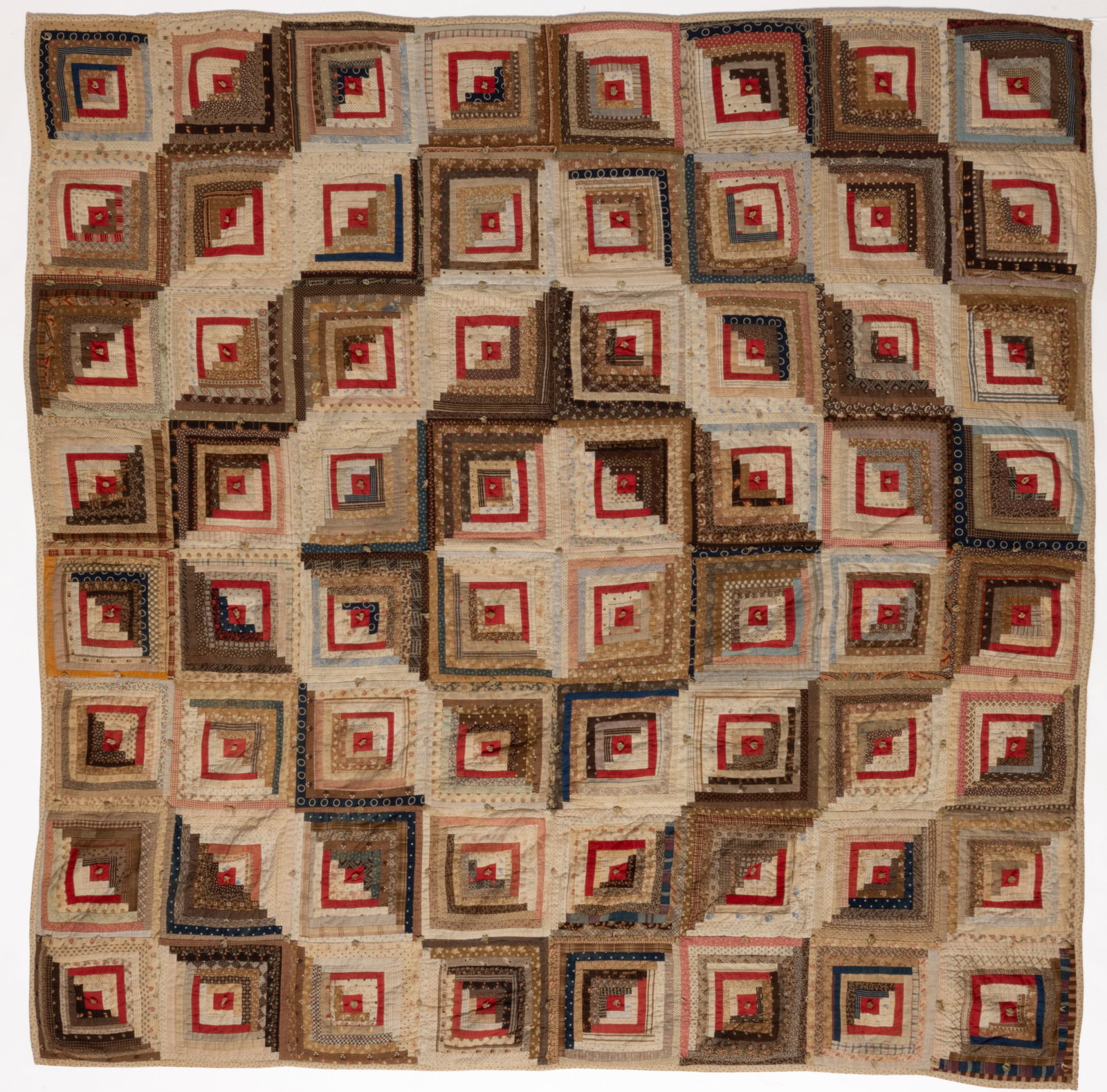 AMERICAN "LOG CABIN - BARN RAISING" PIECED AND TIED COMFORT: AMERICAN "LOG CABIN - BARN RAISING" PIECED AND TIED COMFORT, hand- and machine-stitched, 64 pattern blocks in polychrome print, woven, and solid fabrics with solid red fabric elements