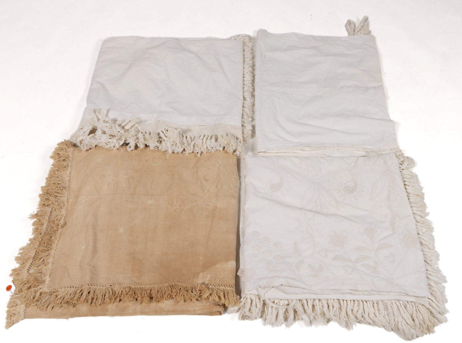 AMERICAN CANDLEWORK EMBROIDERY COUNTERPANES AND BOLSTER COVER, LOT OF FOUR: AMERICAN CANDLEWORK EMBROIDERY COUNTERPANES AND BOLSTER COVER, LOT OF FOUR, each having hand-stitched candlewick embroidery of stylized motifs; comprising a counterpane with hand-stitched construction