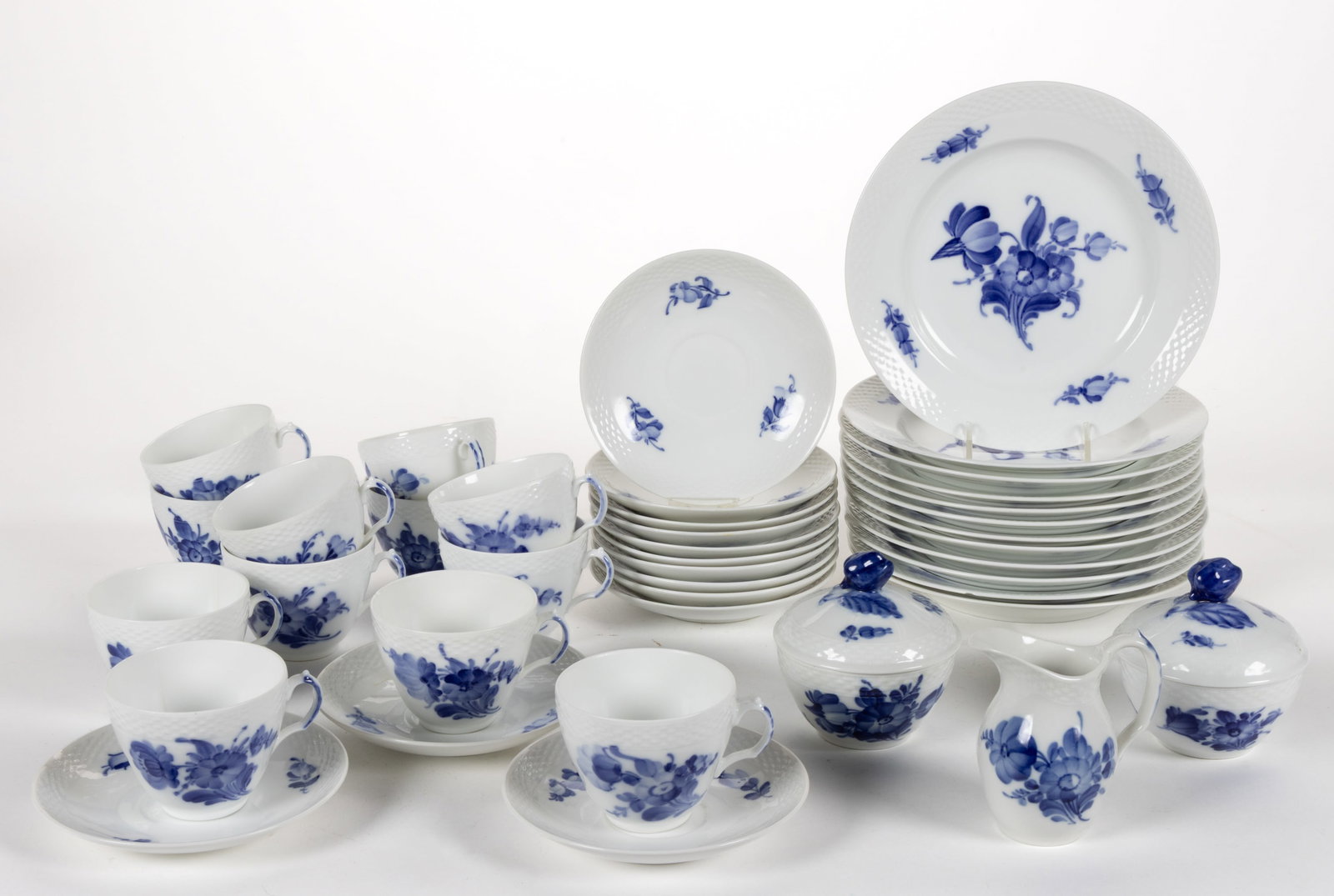 DANISH ROYAL COPENHAGEN PORCELAIN BLUE FLOWERS BRAIDED TEA AND TABLE ARTICLES, LOT OF 40: DANISH ROYAL COPENHAGEN PORCELAIN BLUE FLOWERS BRAIDED TEA AND TABLE ARTICLES, LOT OF 40, each featuring charming blue hand-painted floral designs and molded basketweave border decoration, c