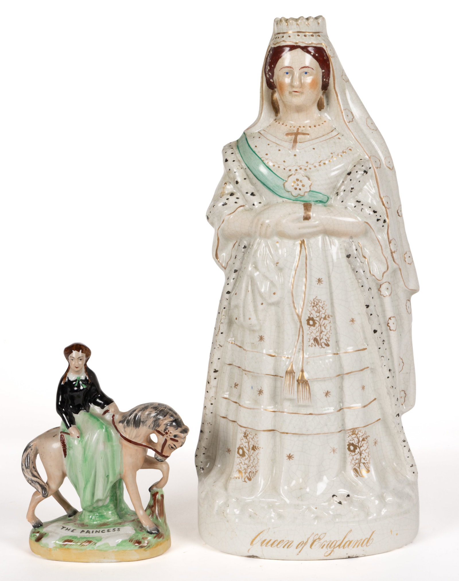 ENGLISH STAFFORDSHIRE HAND-PAINTED CERAMIC ROYAL FAMILY FIGURES, LOT OF TWO: ENGLISH STAFFORDSHIRE HAND-PAINTED CERAMIC ROYAL FAMILY FIGURES, LOT OF TWO, each having polychrome enamel decorations, comprising the "Queen of England" featuring Victoria standing on an ov