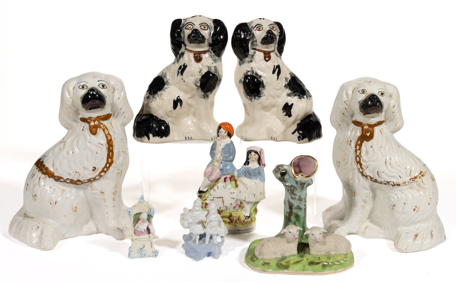 STAFFORDSHIRE AND OTHER CERAMIC FIGURAL ARTICLES, LOT OF EIGHT: STAFFORDSHIRE AND OTHER CERAMIC FIGURAL ARTICLES, LOT OF EIGHT, including a musician figural group depicting a boy holding a wind instrument and sitting on a clock, a spill vase having two recumb