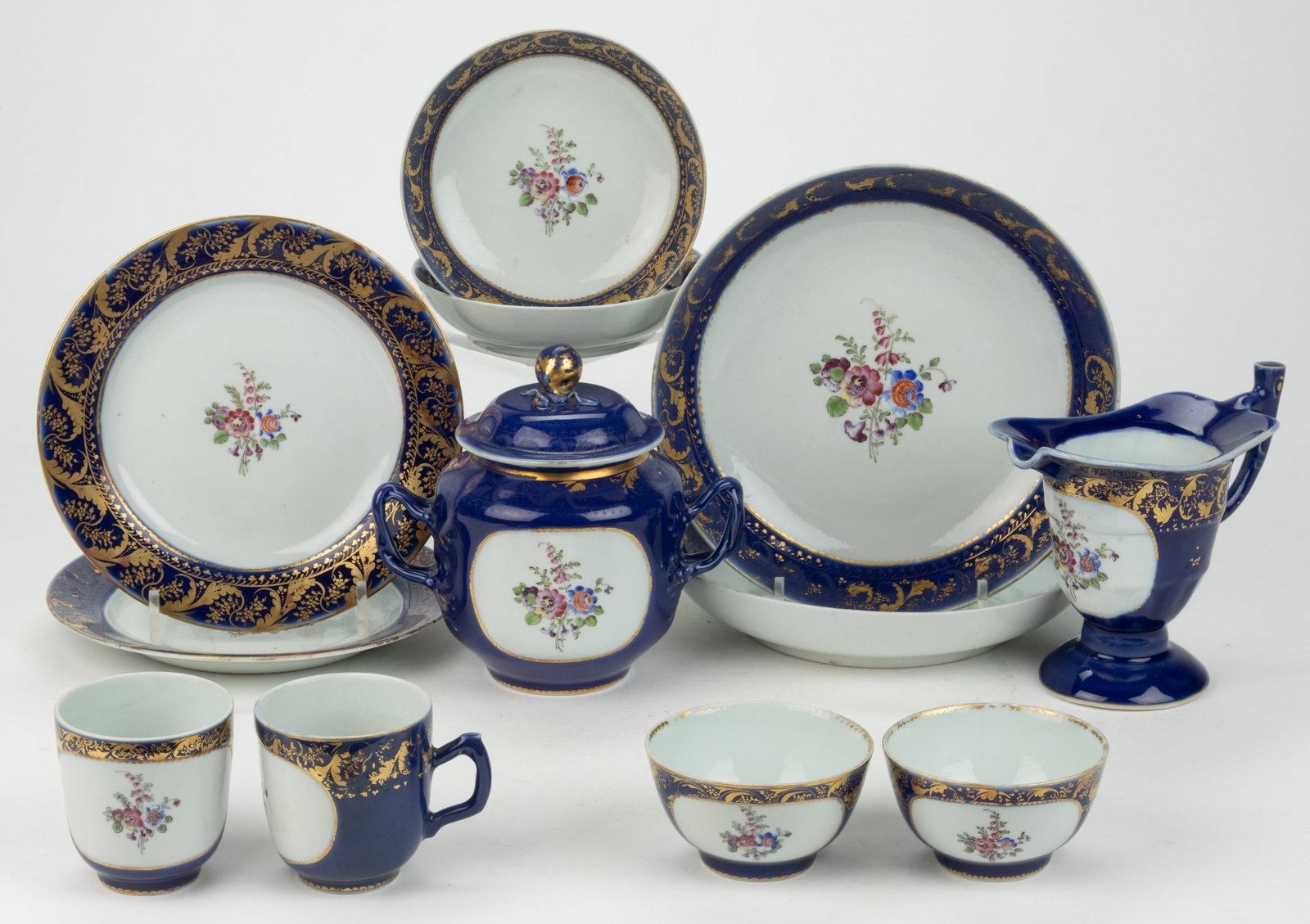 ENGLISH HAND-PAINTED PORCELAIN FLORAL MOTIF AND COBALT-DECORATED TEA AND TABLE ARTICLES, LOT OF 12: ENGLISH HAND-PAINTED PORCELAIN FLORAL MOTIF AND COBALT-DECORATED TEA AND TABLE ARTICLES, LOT OF 12, each featuring a polychrome hand-painted bouquet and cobalt border with gilt flower and scroll decor