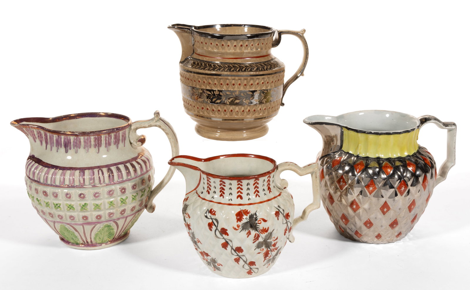 BRITISH MOLDED LUSTRE-DECORATED AND HAND-PAINTED CERAMIC JUGS / PITCHERS, LOT OF FOUR: BRITISH MOLDED LUSTRE-DECORATED AND HAND-PAINTED CERAMIC JUGS / PITCHERS, LOT OF FOUR, comprising one example with molded diamond bands and silver resist foliate-decorated bands, one example with pink