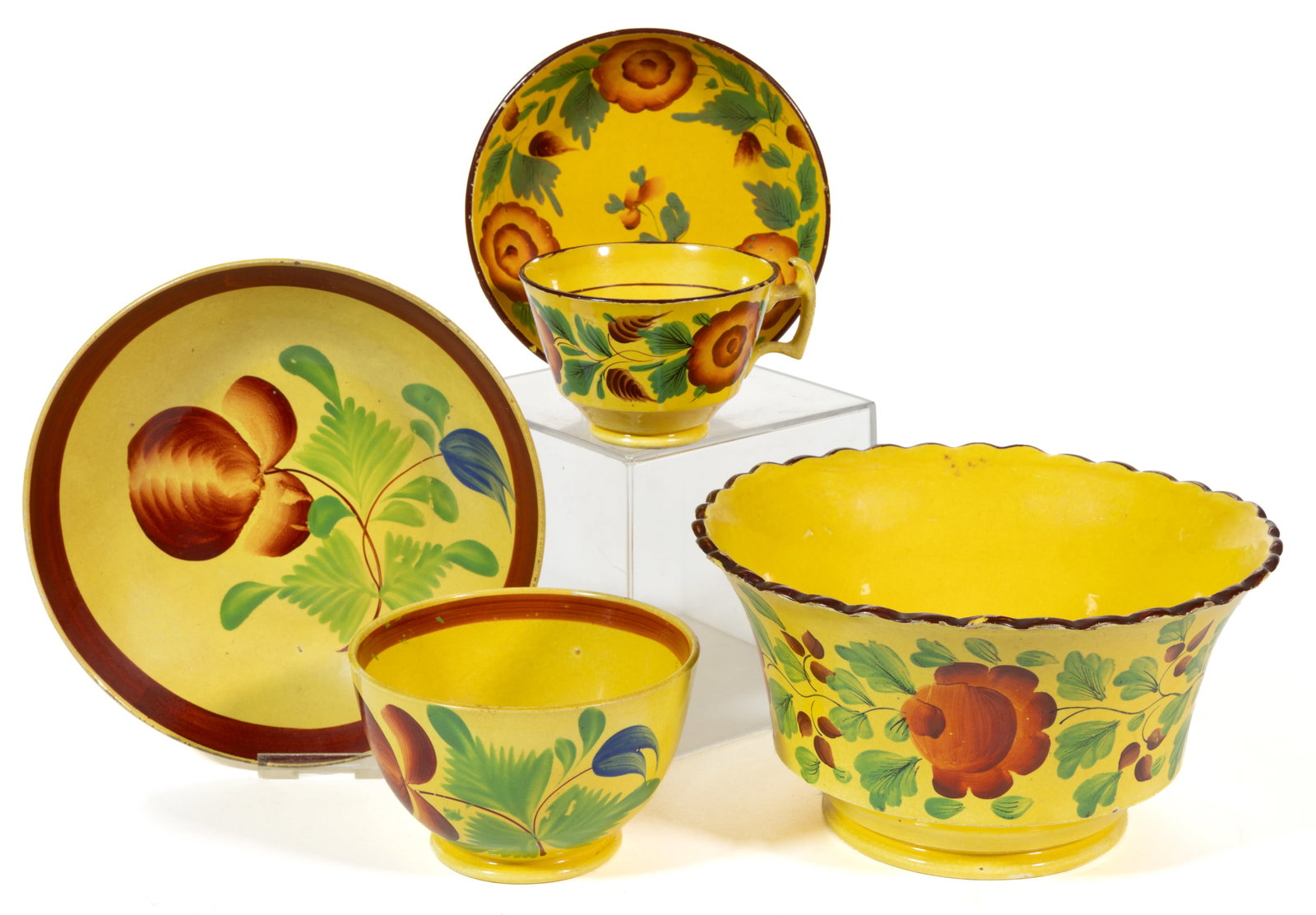 BRITISH CANARY YELLOW HAND-PAINTED FLORAL MOTIF CERAMIC TEA AND TABLE ARTICLES, LOT OF THREE: BRITISH CANARY YELLOW HAND-PAINTED FLORAL MOTIF CERAMIC TEA AND TABLE ARTICLES, LOT OF THREE, each having bold polychrome decorations, comprising a scalloped rim bowl featuring horizontal rose vine mo