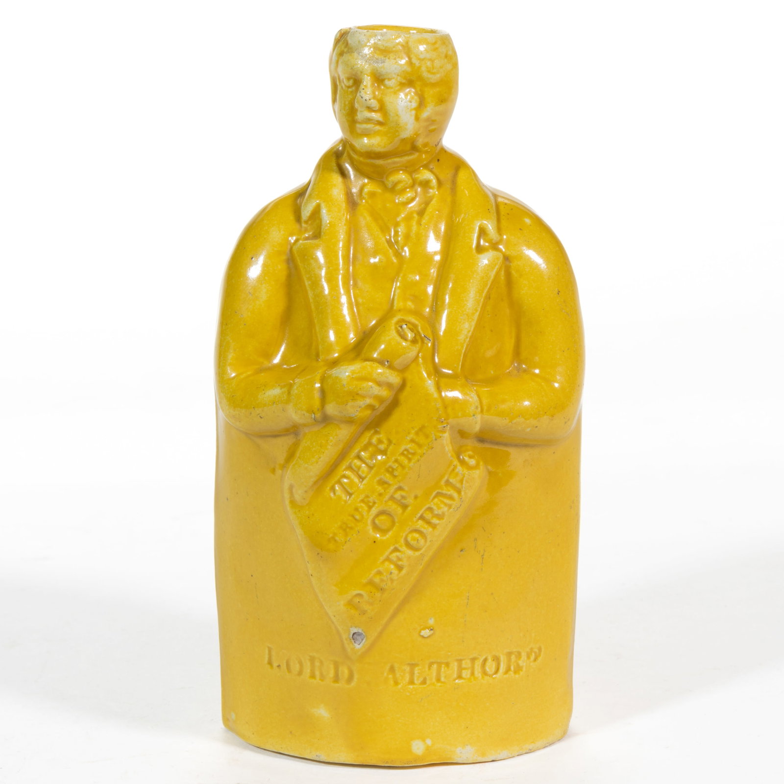 ENGLISH CANARY YELLOW CERAMIC FIGURAL REFORM FLASK: ENGLISH CANARY YELLOW CERAMIC FIGURAL REFORM FLASK, having bright glaze depicting "LORD ALTHOR[P]" holding a scroll with "THE / TRUE-SPIRIT / OF / REFORM". Circa 1830. 6"