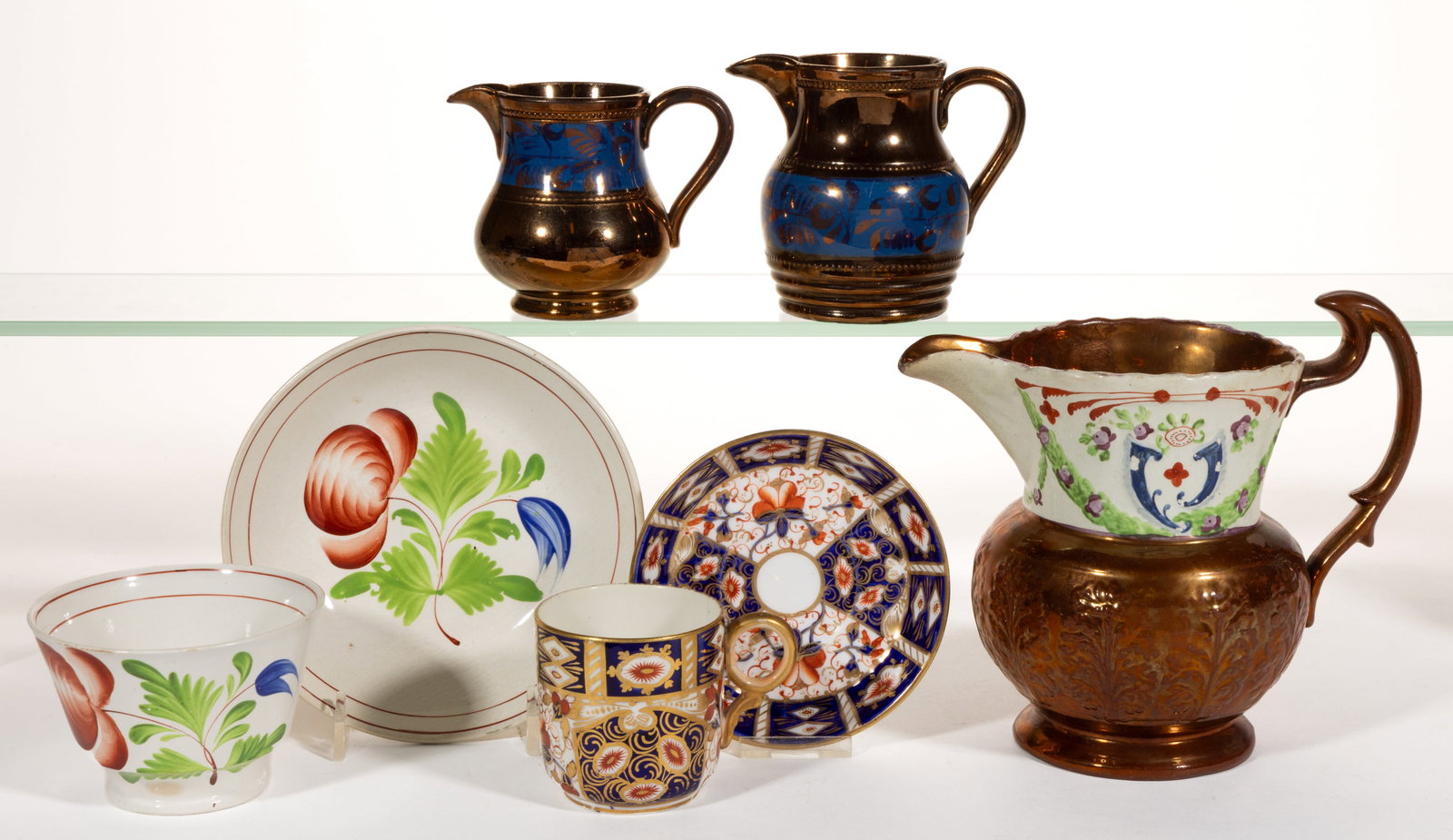 BRITISH HAND-PAINTED CERAMIC DRINKING ARTICLES, LOT OF FIVE: BRITISH HAND-PAINTED CERAMIC DRINKING ARTICLES, LOT OF FIVE, comprising a Royal Crown Derby cup and saucer set with Traditional Imari pattern, a cup and saucer set featuring hand-painted Tulip Rose mo