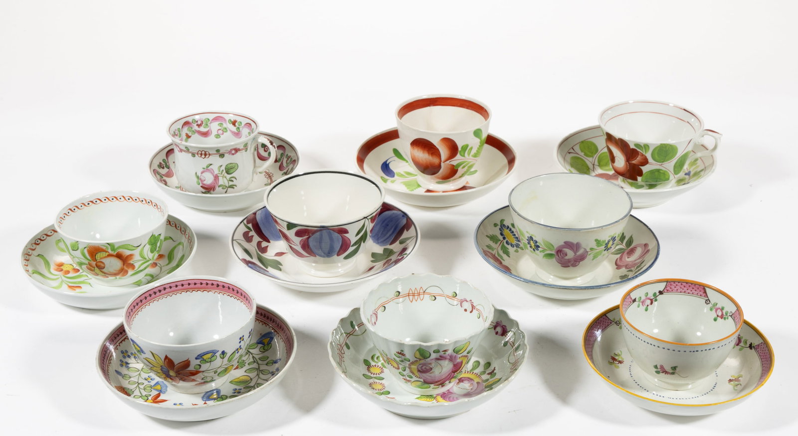 BRITISH HAND-PAINTED FLORAL MOTIF CUP AND SAUCER SETS, LOT OF NINE: BRITISH HAND-PAINTED FLORAL MOTIF CUP AND SAUCER SETS, LOT OF NINE, including one featuring additional strawberry decorations, one having King's Rose pattern, one with Tulip Rose motif, one having