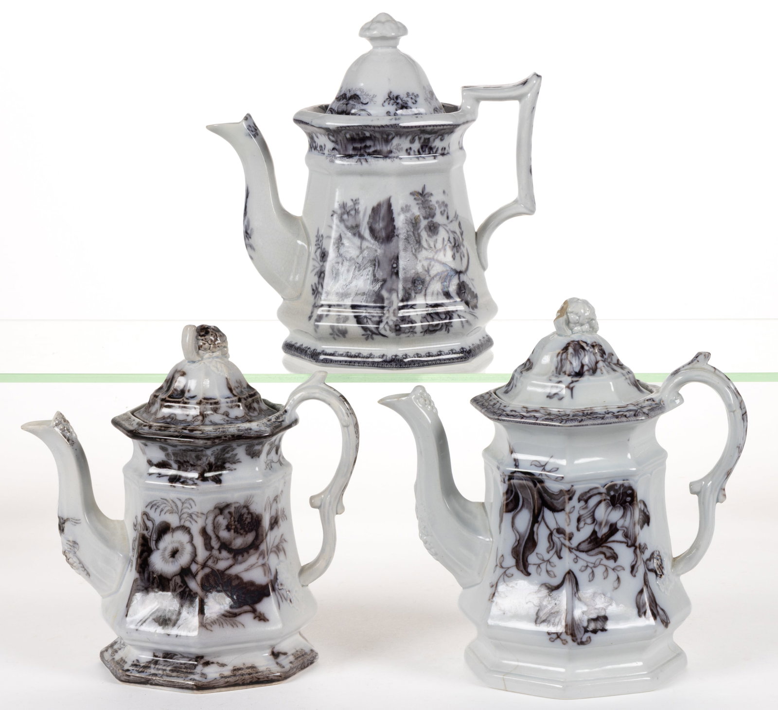 ENGLISH STAFFORDSHIRE FLOW-DECORATED / MULBERRY FLORAL MOTIF IRONSTONE COFFEE POTS, LOT OF THREE: ENGLISH STAFFORDSHIRE FLOW-DECORATED / MULBERRY FLORAL MOTIF IRONSTONE COFFEE POTS, LOT OF THREE, each of octagonal form, comprising one example having Wild Rose pattern and two examples having grape-