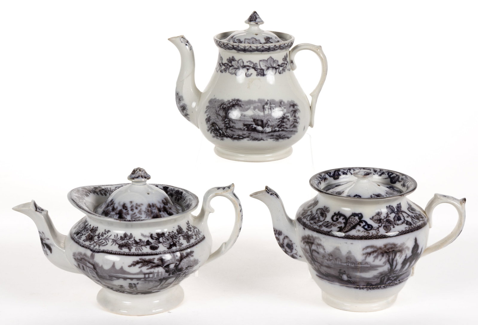 ENGLISH STAFFORDSHIRE FLOW-DECORATED / MULBERRY SCENIC MOTIF IRONSTONE TEAPOTS, LOT OF THREE: ENGLISH STAFFORDSHIRE FLOW-DECORATED / MULBERRY SCENIC MOTIF IRONSTONE TEAPOTS, LOT OF THREE, each having rounded body, comprising one example having vine and berry border and depicting a woman sittin