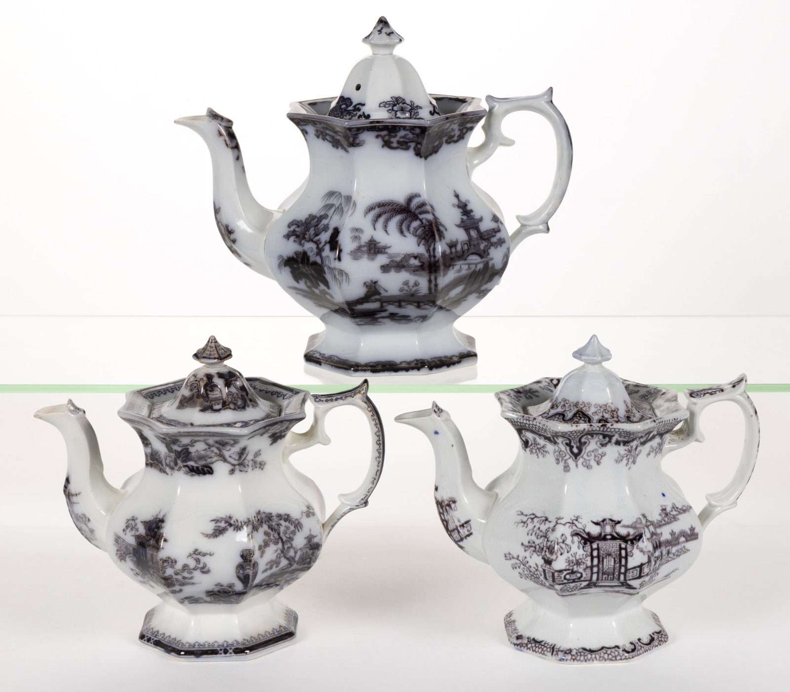ENGLISH STAFFORDSHIRE FLOW-DECORATED / MULBERRY CHINOISERIE MOTIF IRONSTONE COFFEE POTS, LOT OF: ENGLISH STAFFORDSHIRE FLOW-DECORATED / MULBERRY CHINOISERIE MOTIF IRONSTONE COFFEE POTS, LOT OF THREE, each of octagonal primary form, comprising "SHAPOO", "JEDDO" and Lintin. Mark