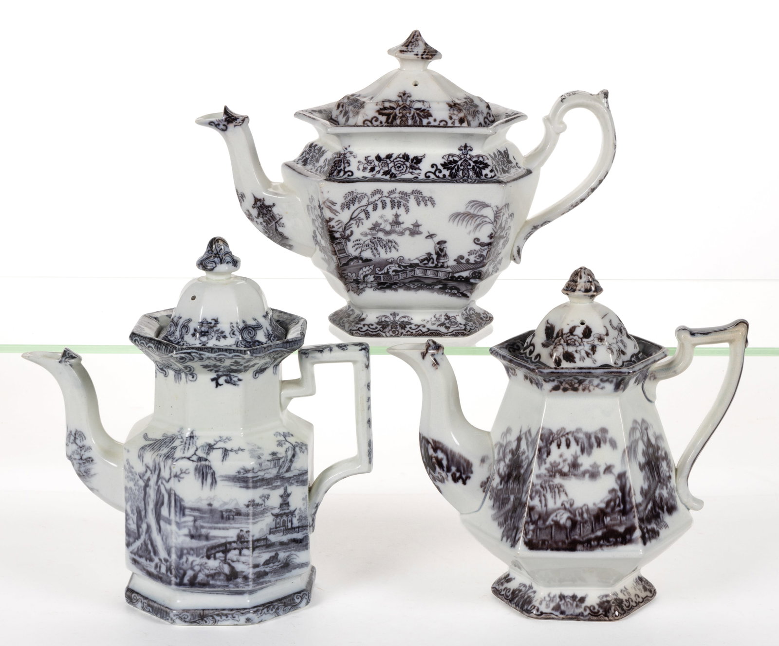 ENGLISH STAFFORDSHIRE FLOW-DECORATED / MULBERRY CHINOISERIE MOTIF IRONSTONE COFFEE POTS, LOT OF: ENGLISH STAFFORDSHIRE FLOW-DECORATED / MULBERRY CHINOISERIE MOTIF IRONSTONE COFFEE POTS, LOT OF THREE, comprising one Gothic-form example with recessed neck featuring Beauties of China pattern an
