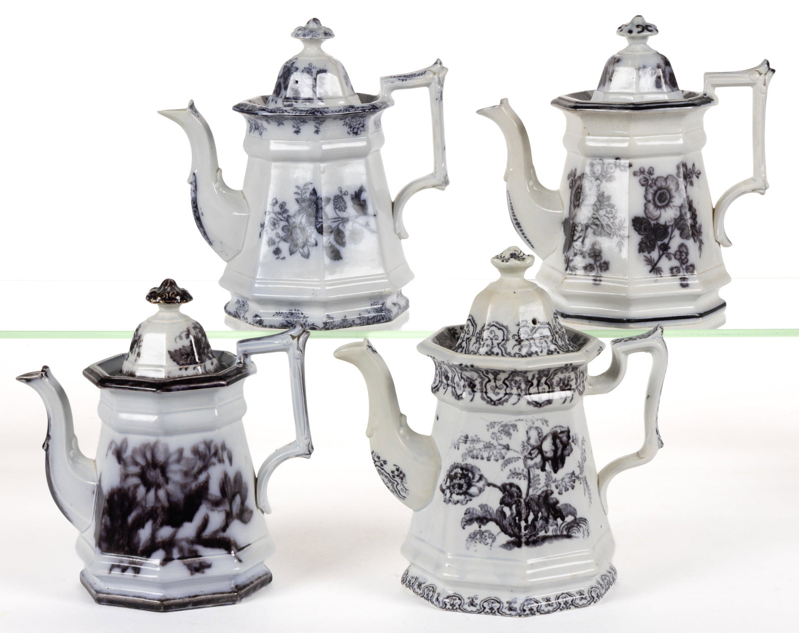 ENGLISH STAFFORDSHIRE FLOW-DECORATED / MULBERRY FLORAL MOTIF IRONSTONE COFFEE POTS, LOT OF FOUR: ENGLISH STAFFORDSHIRE FLOW-DECORATED / MULBERRY FLORAL MOTIF IRONSTONE COFFEE POTS, LOT OF FOUR, each of octagonal form, comprising patterns including "FLORA", Neva, and one featuring two re