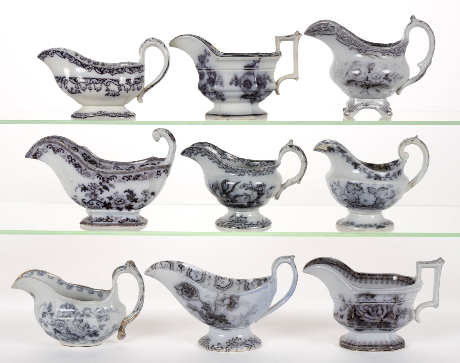 BRITISH / STAFFORDSHIRE FLOW-DECORATED / MULBERRY FLORAL MOTIF IRONSTONE SAUCE BOATS, LOT OF NINE: BRITISH / STAFFORDSHIRE FLOW-DECORATED / MULBERRY FLORAL MOTIF IRONSTONE SAUCE BOATS, LOT OF NINE, comprising a four-footed example, two globular-form examples having Ivy & Flower and Summer 