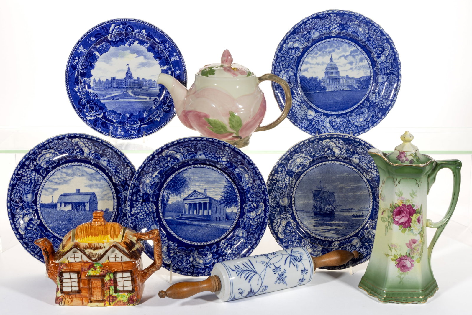 ASSORTED CERAMIC TEA AND OTHER ARTICLES, LOT OF NINE: ASSORTED CERAMIC TEA AND OTHER ARTICLES, LOT OF NINE, comprising a Meissen-style porcelain rolling pin with Blue Onion pattern, a Buffalo Pottery chocolate pot featuring polychrome rose transfer, two 