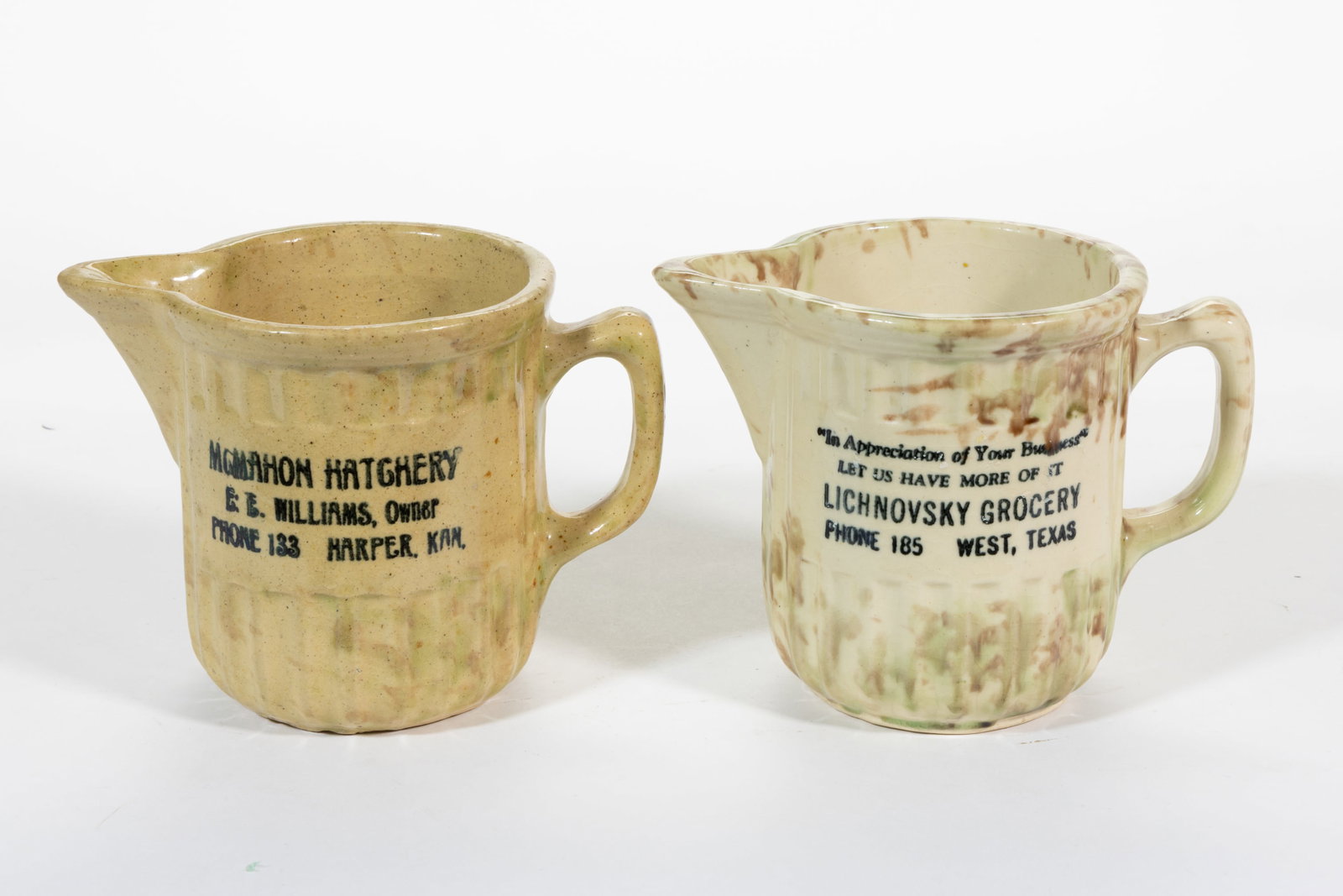 AMERICAN SPONGE-DECORATED STONEWARE KANSAS AND TEXAS COUNTRY ADVERTISING PITCHERS, LOT OF TWO (1 of 2)