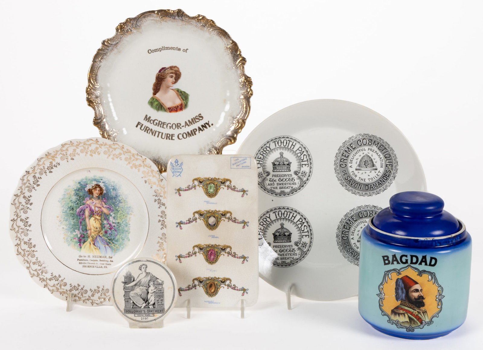 ASSORTED ADVERTISING CERAMIC ARTICLES, LOT OF SIX: ASSORTED ADVERTISING CERAMIC ARTICLES, LOT OF SIX, comprising a covered humidor featuring transfer image of a bearded man wearing a fez and "BAGDAD" above, a pot lid having black transfer fe