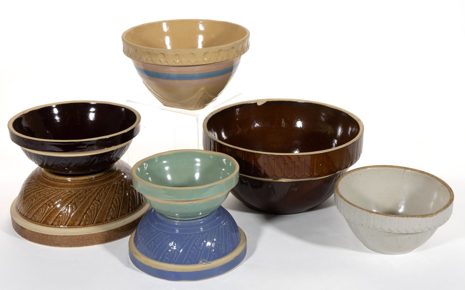 AMERICAN STONEWARE BOWLS, LOT OF SEVEN: AMERICAN STONEWARE BOWLS, LOT OF SEVEN, comprising a yellow-glazed example with pink and blue-glazed bands, a four-piece graduated set with matching stylized feather design consisting of a green,