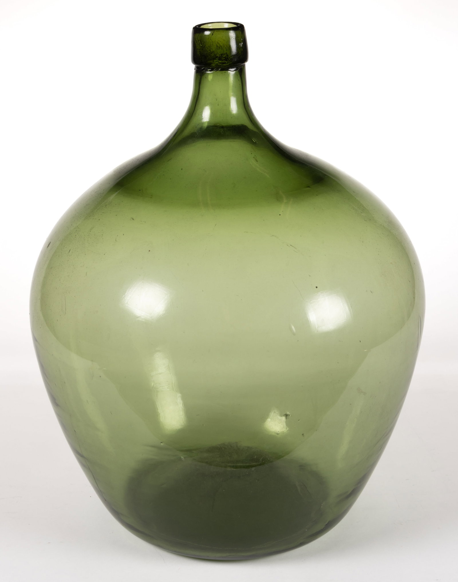 BLOWN-MOLDED GLASS DEMIJOHN / LARGE UTILITY BOTTLE: BLOWN-MOLDED GLASS DEMIJOHN / LARGE UTILITY BOTTLE, medium green, large size, flattened globular or bladder-form body with rounded shoulder and mid-sized neck, large applied tapered mouth, kick-u