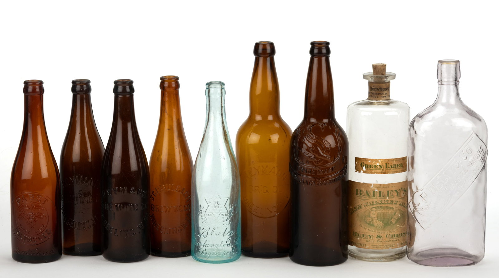 WEST VIRGINIA AND OTHER BEER / WHISKEY BOTTLES, LOT OF NINE: WEST VIRGINIA AND OTHER BEER / WHISKEY BOTTLES, LOT OF NINE, colorless, comprising P. Welty & Co., Wines & Liquors, Wheeling, WV, and Bailey's Whiskey, Philadelphia, with original labels;