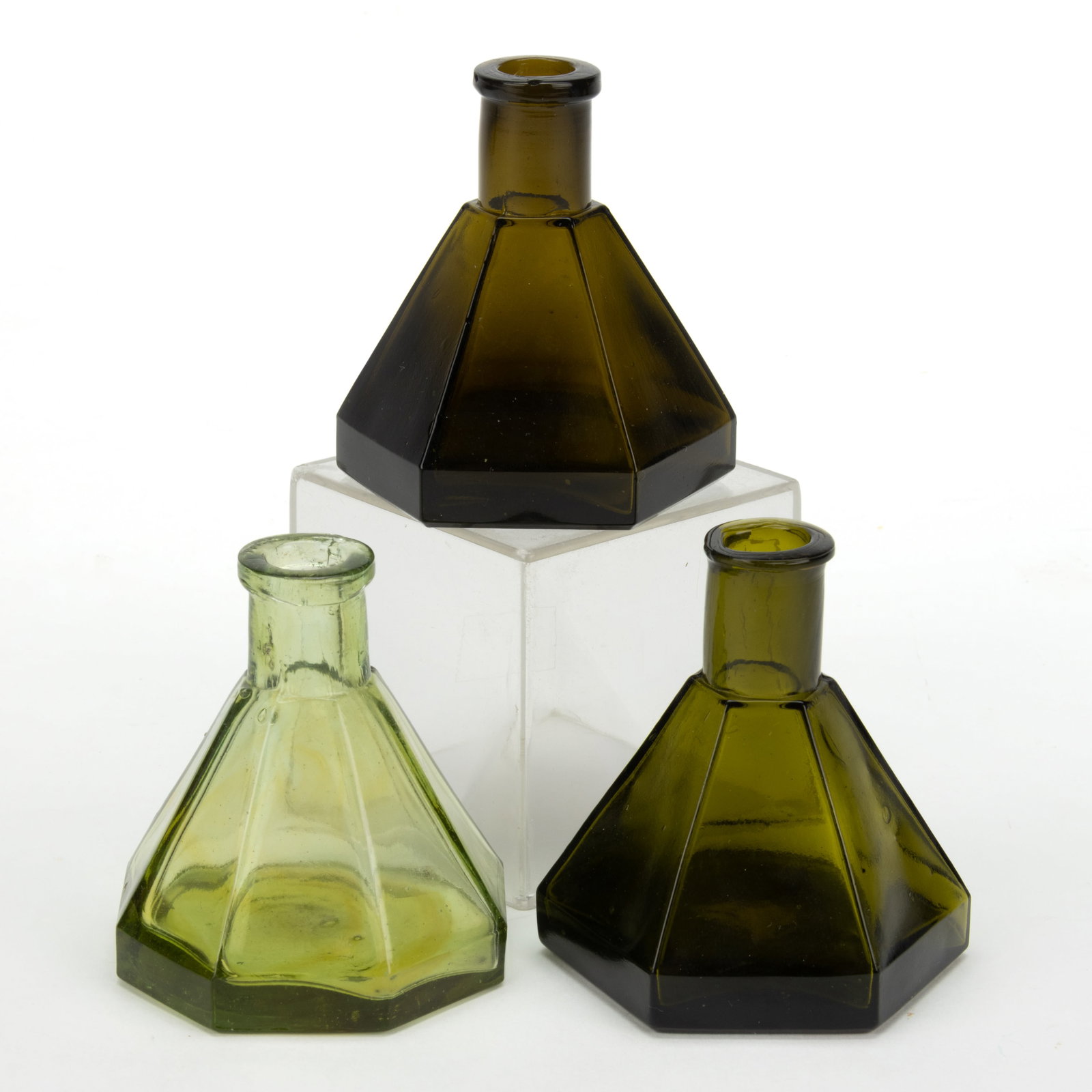 ASSORTED CONICAL PANELLED UMBRELLA INKWELLS / BOTTLES, LOT OF THREE: ASSORTED CONICAL PANELLED UMBRELLA INKWELLS / BOTTLES, LOT OF THREE, comprising a light yellow-olive green octagonal example with squared mouth and plain base, and emerald green and olive green hexago