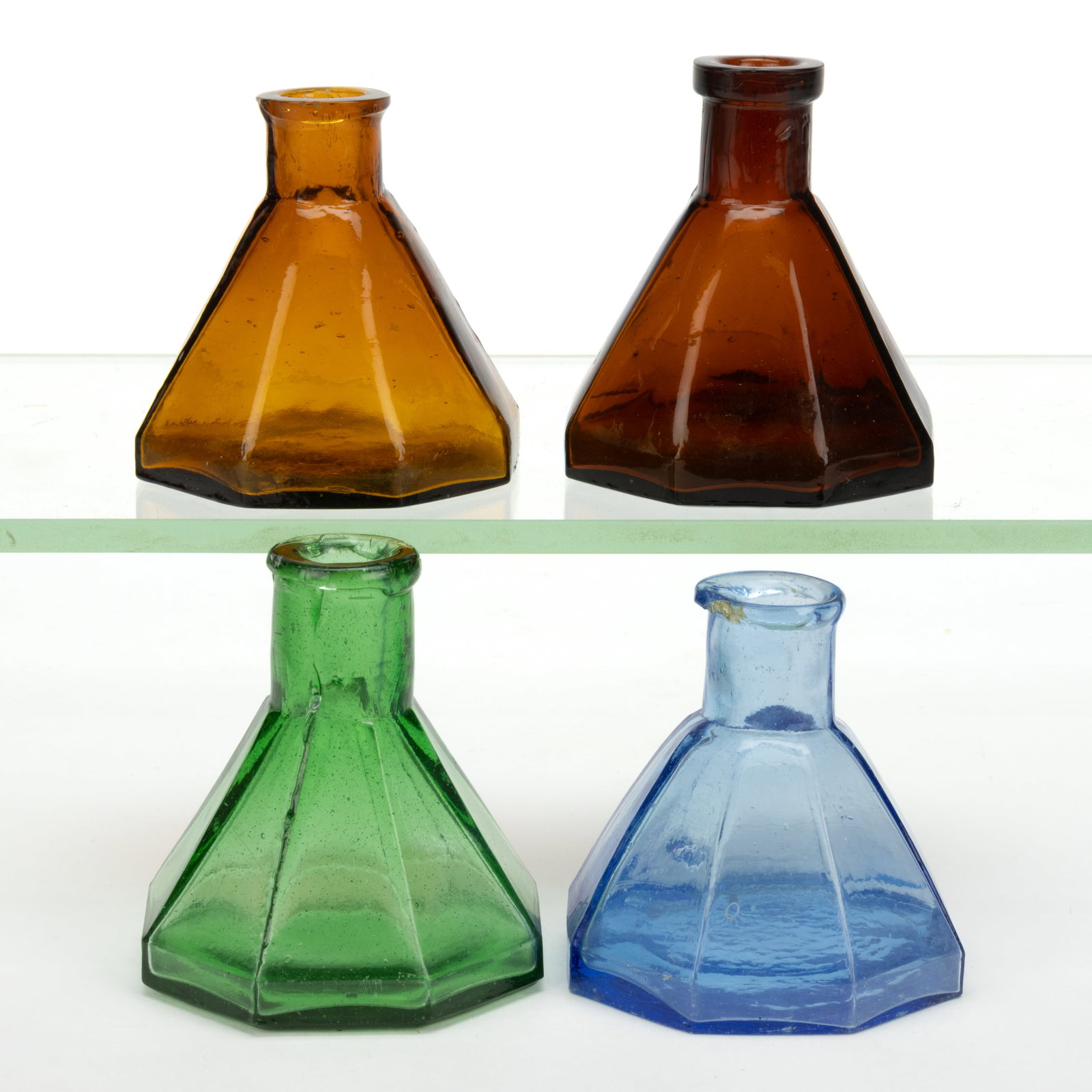 ASSORTED CONICAL PANELLED UMBRELLA INKWELLS / BOTTLES, LOT OF FOUR: ASSORTED CONICAL PANELLED UMBRELLA INKWELLS / BOTTLES, LOT OF FOUR, yellow amber, red amber, cornflower blue, and emerald green, each of octagonal form with plain base, three with tooled mouth an