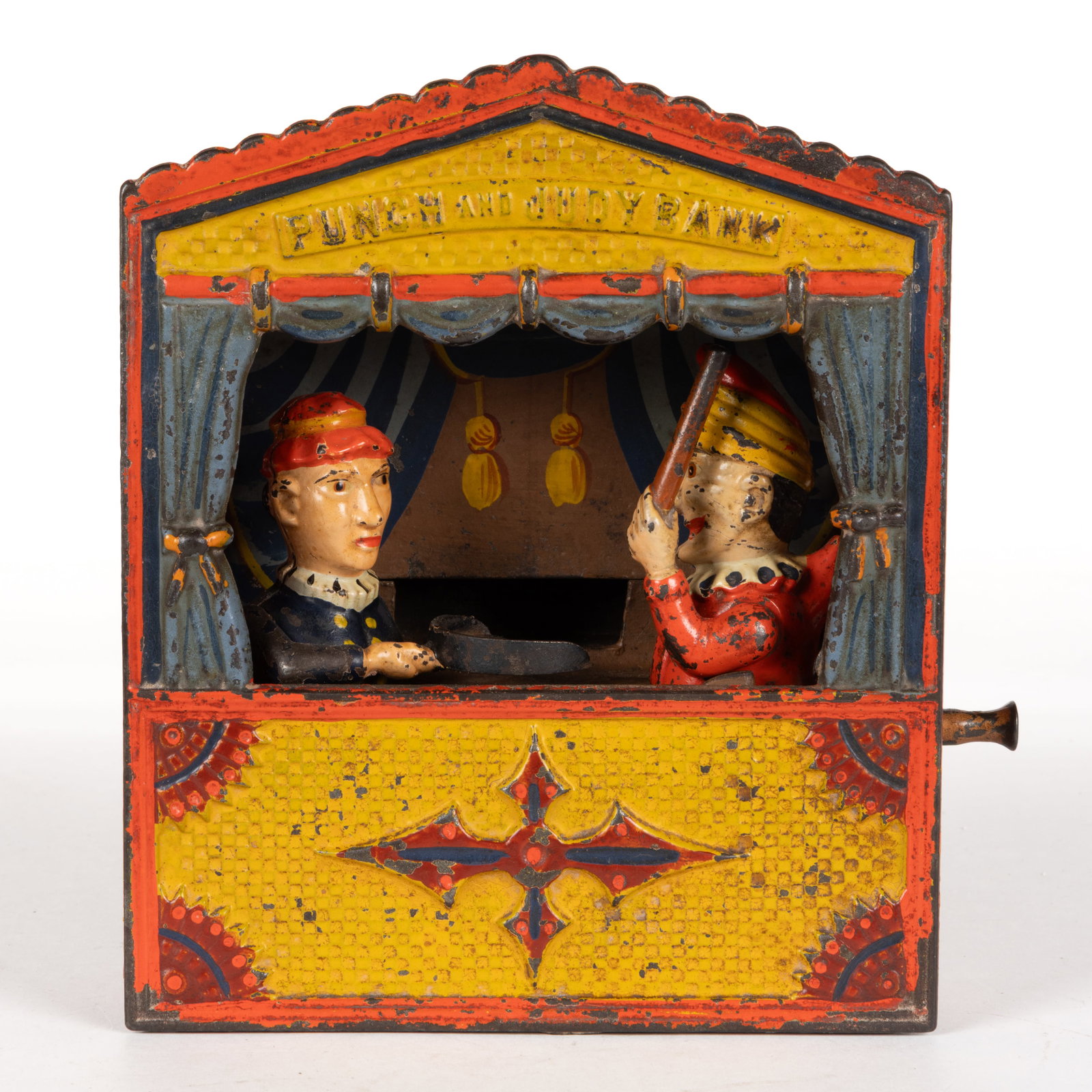 PUNCH AND JUDY CAST-IRON MECHANICAL BANK: PUNCH AND JUDY CAST-IRON MECHANICAL BANK, small letters, marked "BUFFALO. NY. - U.S.A. / PATD IN U.S. JULY 15. '84 / AND JULY 22. '84 / RD IN ENGLAND" to underside of base, reta