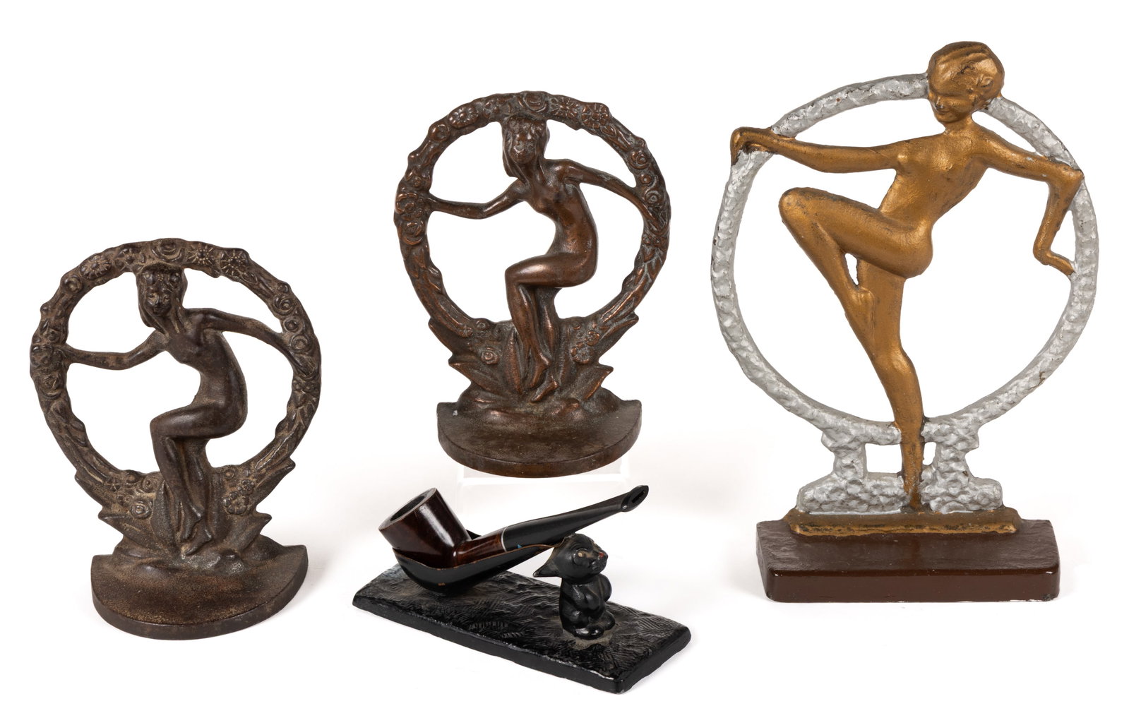 ART DECO METAL ARTICLES, LOT OF FOUR: ART DECO METAL ARTICLES, LOT OF FOUR, comprising a pair of bronze-patinated cast-iron bookends and a painted cast-iron doorstop, each featuring a dancing nude within a wreath, and a painted white-meta