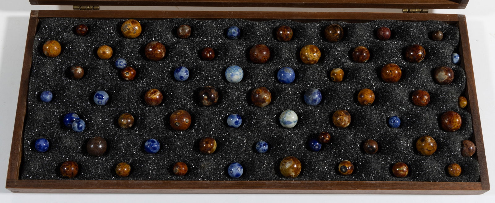 ASSORTED CLAY MARBLES, UNCOUNTED LOT: ASSORTED CLAY MARBLES, UNCOUNTED LOT, including some Blue and Brown Bennington glazed examples. Together with wooden case. Various makers. 19th and 20th century. 3/8" to 3/4" D. Provenance: 