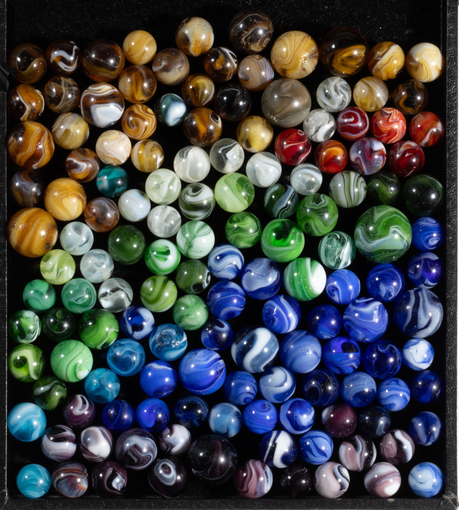ASSORTED SLAG MACHINE-MADE MARBLES, LOT OF 140: ASSORTED SLAG MACHINE-MADE MARBLES, LOT OF 140, including amber, blue, electric blue, green, purple, opal, and three fluorescents (react under black light). Christensen Agate Co., Akro Agate Co.,