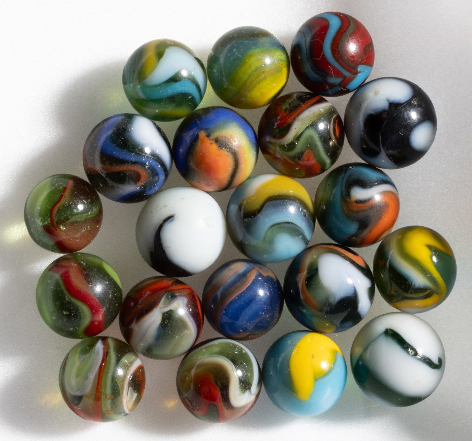 ASSORTED PELTIER MACHINE-MADE MARBLES, LOT OF 20: ASSORTED PELTIER MACHINE-MADE MARBLES, LOT OF 20, including a Spiderman and a Polar Bear. Peltier Glass Co. Second quarter 20th century. 19/32" to 23/32" D. Provenance: F