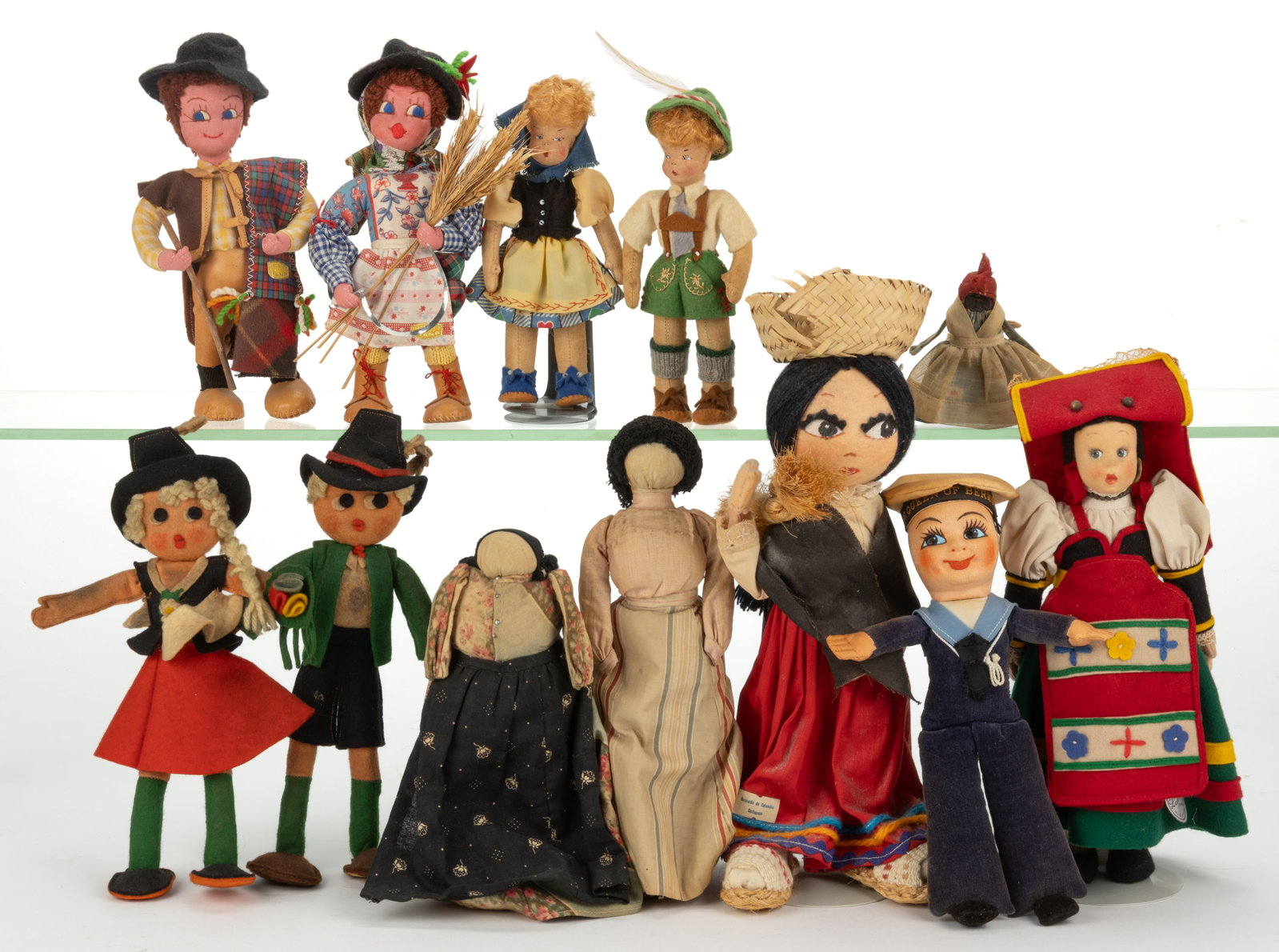 ASSORTED CLOTH AND FELT DOLLS, LOT OF 12: ASSORTED CLOTH AND FELT DOLLS, LOT OF 12, most having painted or sewn facial features and jointed limbs, comprising of a Lenci Torino example, retains a paper hand tag; an Empire example depictin