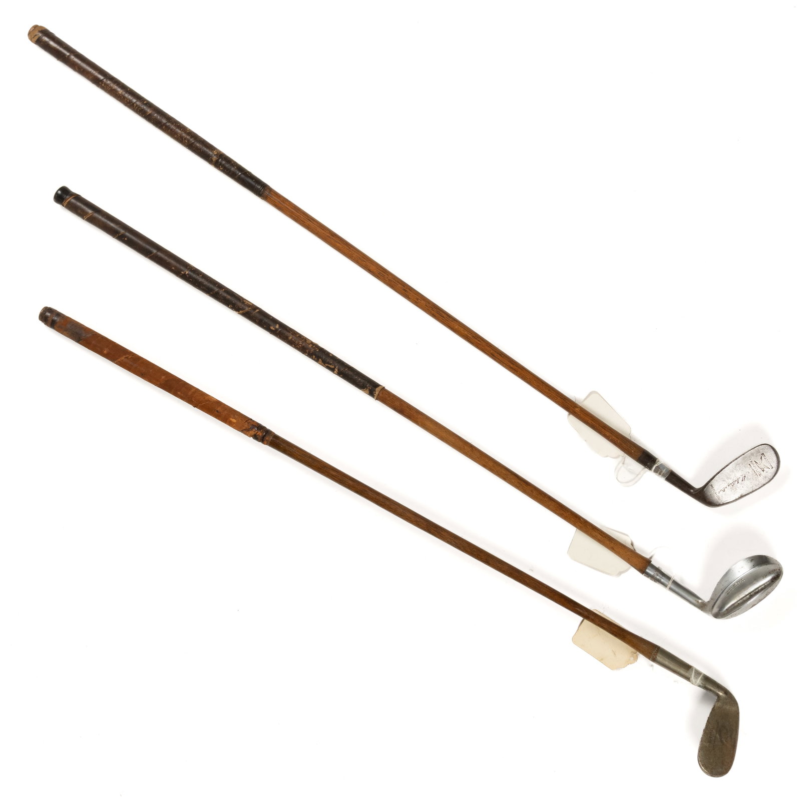 ASSORTED HICKORY-SHAFT GOLF CLUBS, LOT OF THREE: ASSORTED HICKORY-SHAFT GOLF CLUBS, LOT OF THREE, comprising a Stewart Antishank; a Walter Hagen concave sand wedge; and a Spalding Kro Flite waterfall-pattern deadstop. One example for a left-handed p