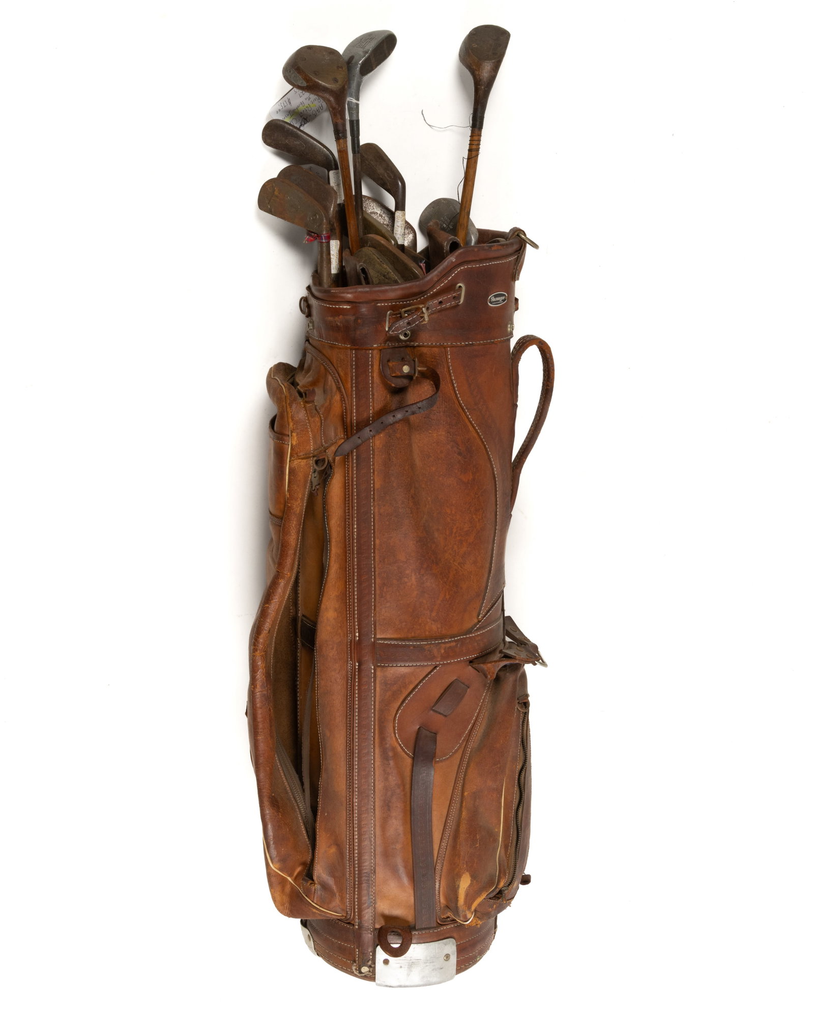 ASSORTED HICKORY-SHAFT AND OTHER GOLF CLUBS AND BAG, LOT OF 16: ASSORTED HICKORY-SHAFT AND OTHER GOLF CLUBS AND BAG, LOT OF 16, makers including Spalding, Burke, and a Butchart Cleek with a gutta percha insert, the leather bag retains a for Slazenger. First half 2