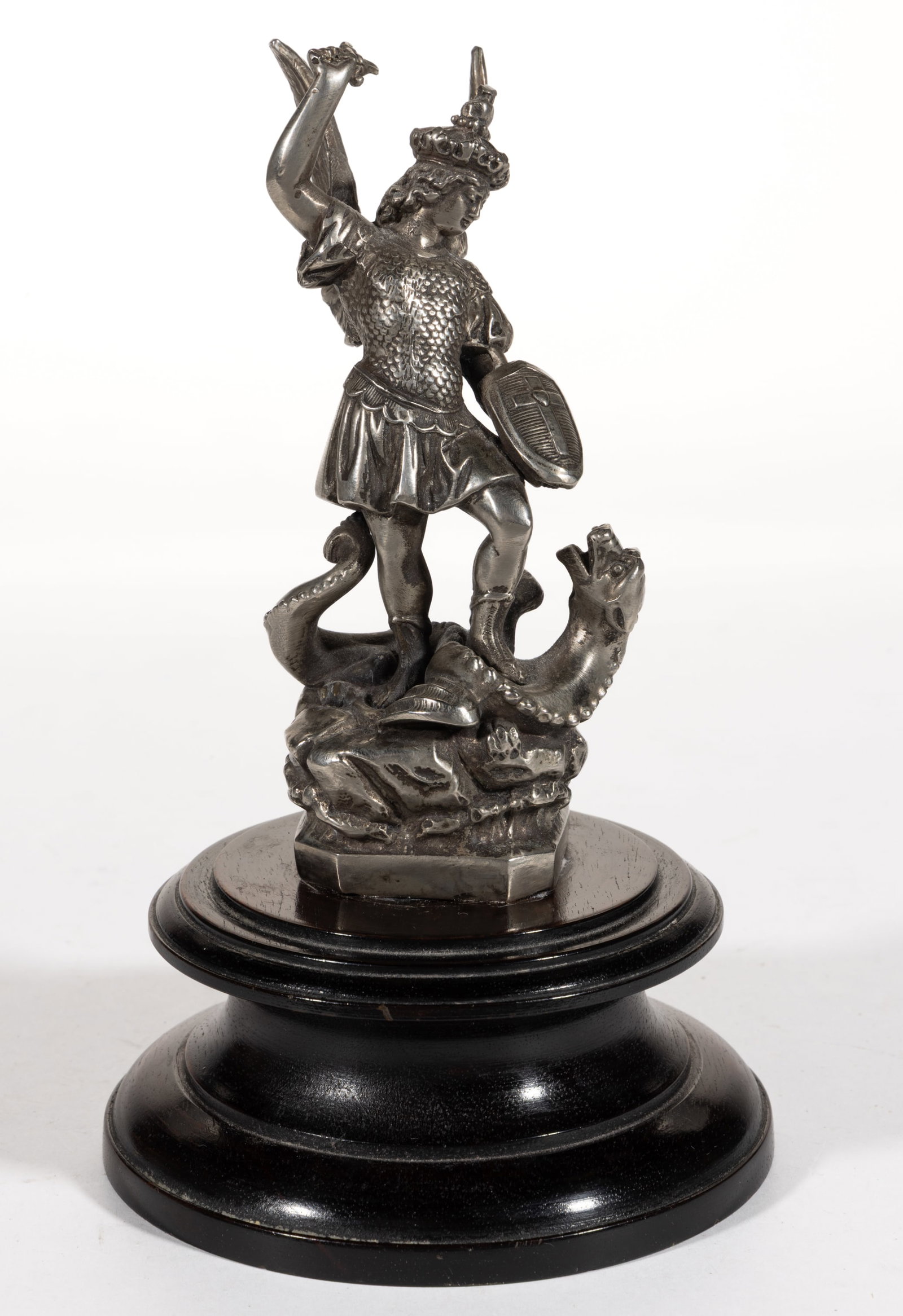 SAINT GEORGE AND THE DRAGON AUTOMOBILE MASCOT / HOOD / RADIATOR ORNAMENT: SAINT GEORGE AND THE DRAGON AUTOMOBILE MASCOT / HOOD / RADIATOR ORNAMENT, of a silver-like metal, possibly silver of unknown fineness, depicting Saint George slaying the dragon, mounted to a late