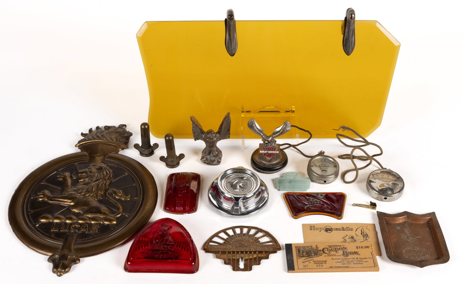 ASSORTED AUTOMOBILE AND RELATED ARTICLES, UNCOUNTED LOT: ASSORTED AUTOMOBILE AND RELATED ARTICLES, UNCOUNTED LOT, including an amber-tinted sun shield or visor with beveled edges and nickel-plated mounting hardware; 1940s Plymouth lens covers; a Farmers Ins