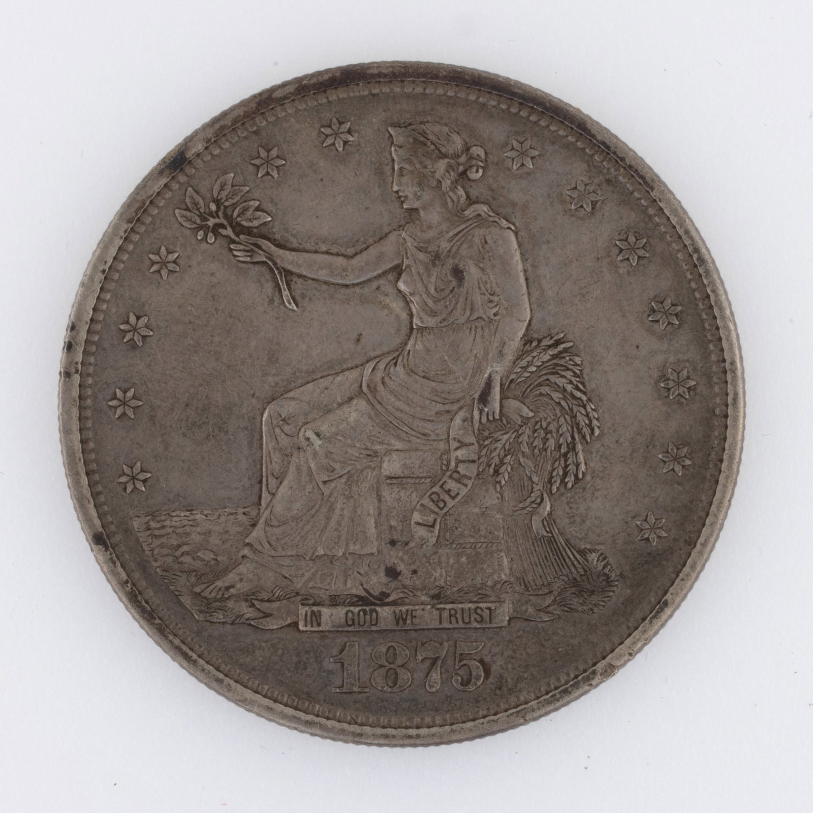 UNITED STATES SILVER 1875 SEATED LIBERTY TRADE DOLLAR COIN: UNITED STATES SILVER 1875 SEATED LIBERTY TRADE DOLLAR COIN. Provenance: The estate collection of Dennis Trischler, Woodbridge, VA.
