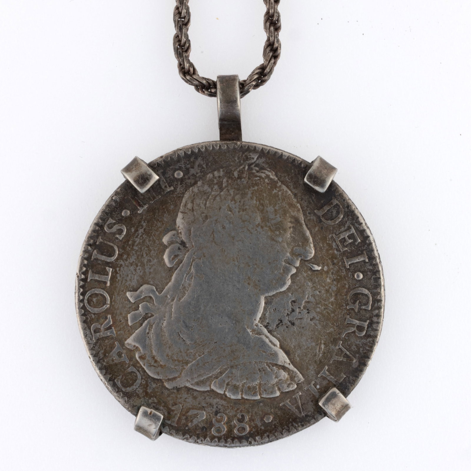 MEXICO 1788 SPANISH COLONIAL SILVER EIGHT REALE COIN: MEXICO 1788 SPANISH COLONIAL SILVER EIGHT REALE COIN, with "Mo" mint mark for Mexico City. Mounted in an unmarked, probably sterling four-prong bezel on a marked sterling rope-style chain. T