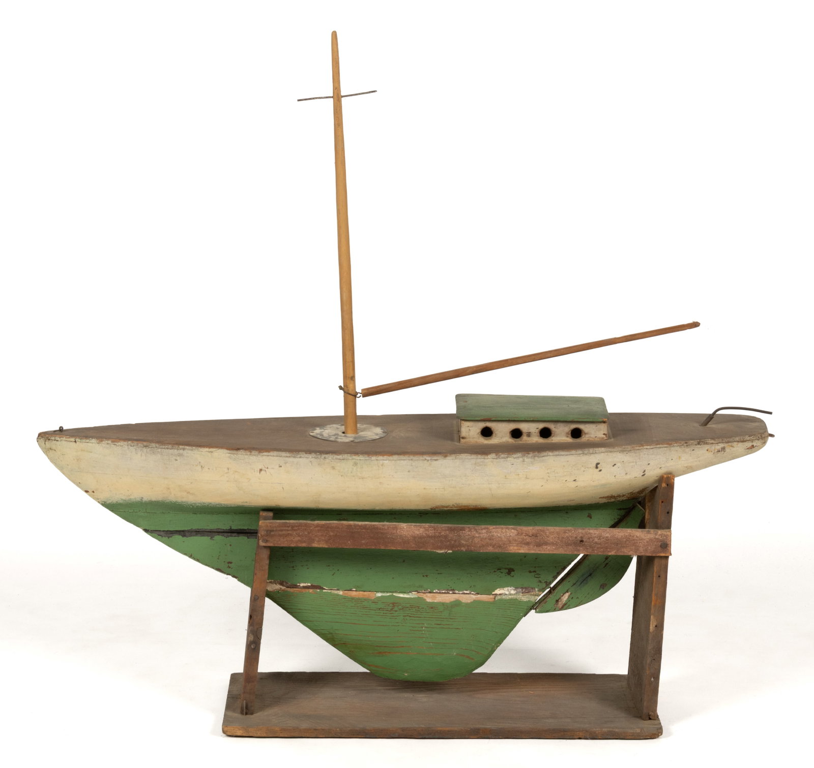 AMERICAN FOLK ART CARVED AND PAINTED MODEL / POND BOAT: AMERICAN FOLK ART CARVED AND PAINTED MODEL / POND BOAT, hollow hull with a flat deck and deep lower projection. Housed in the likely original period make-do stand made from reused crates. Retains
