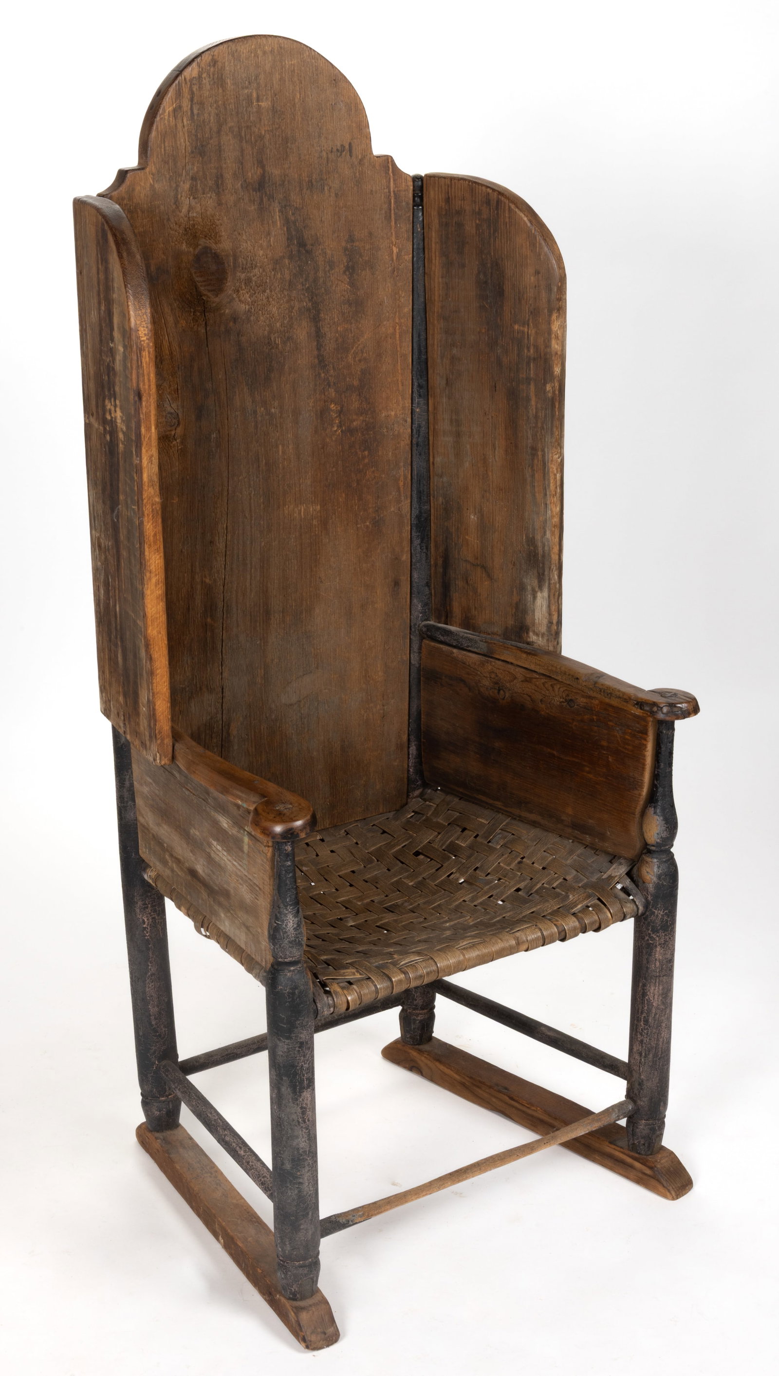NEW ENGLAND PAINTED MAKE-DO FIRESIDE ARMCHAIR: NEW ENGLAND PAINTED MAKE-DO FIRESIDE ARMCHAIR, having a shaped back over canted wings with a curved front profile over shaped arms and a trapezoidal splint seat, the whole raised on turned legs