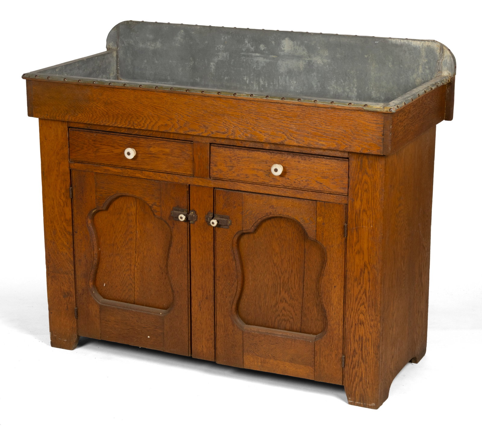 AMERICAN OAK DRYSINK: AMERICAN OAK DRYSINK, classic form with open zinc-lined well over two short drawers above two fielded-panel doors concealing single fixed shelf, all flanked by solid ends and raised on a simple