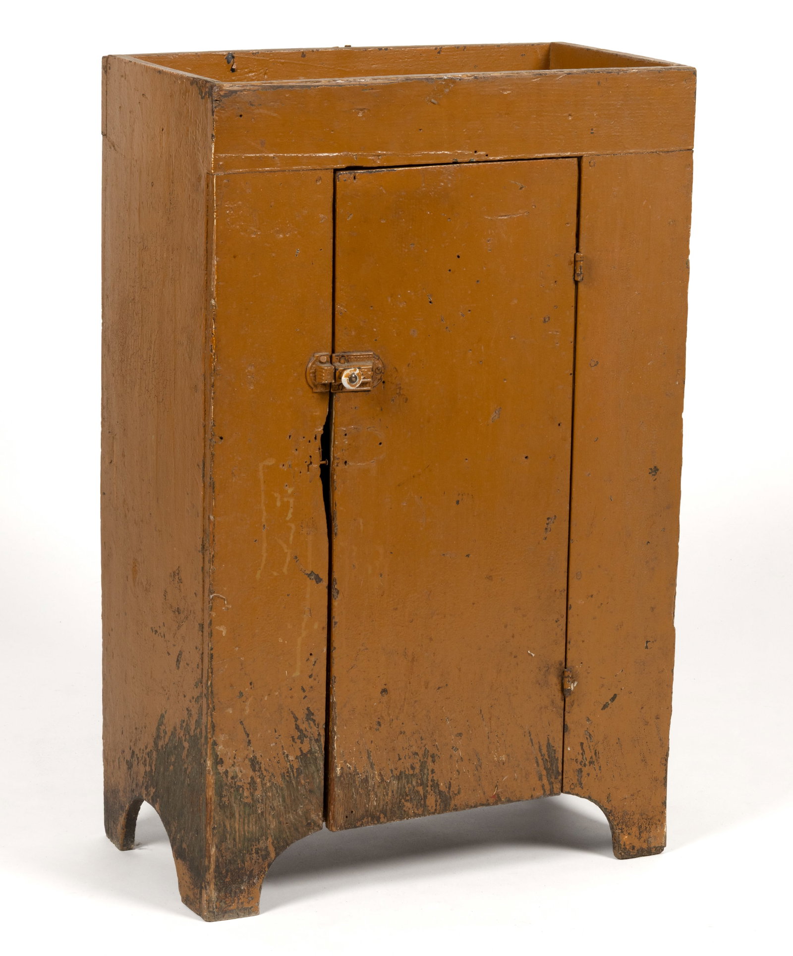 AMERICAN COUNTRY PAINTED CHESTNUT CHILD'S CUPBOARD: AMERICAN COUNTRY PAINTED CHESTNUT CHILD'S CUPBOARD, the simple form with open well above a single hinged plank door concealing two fixed shelves, all flanked by solid ends and raised on a cut-out 