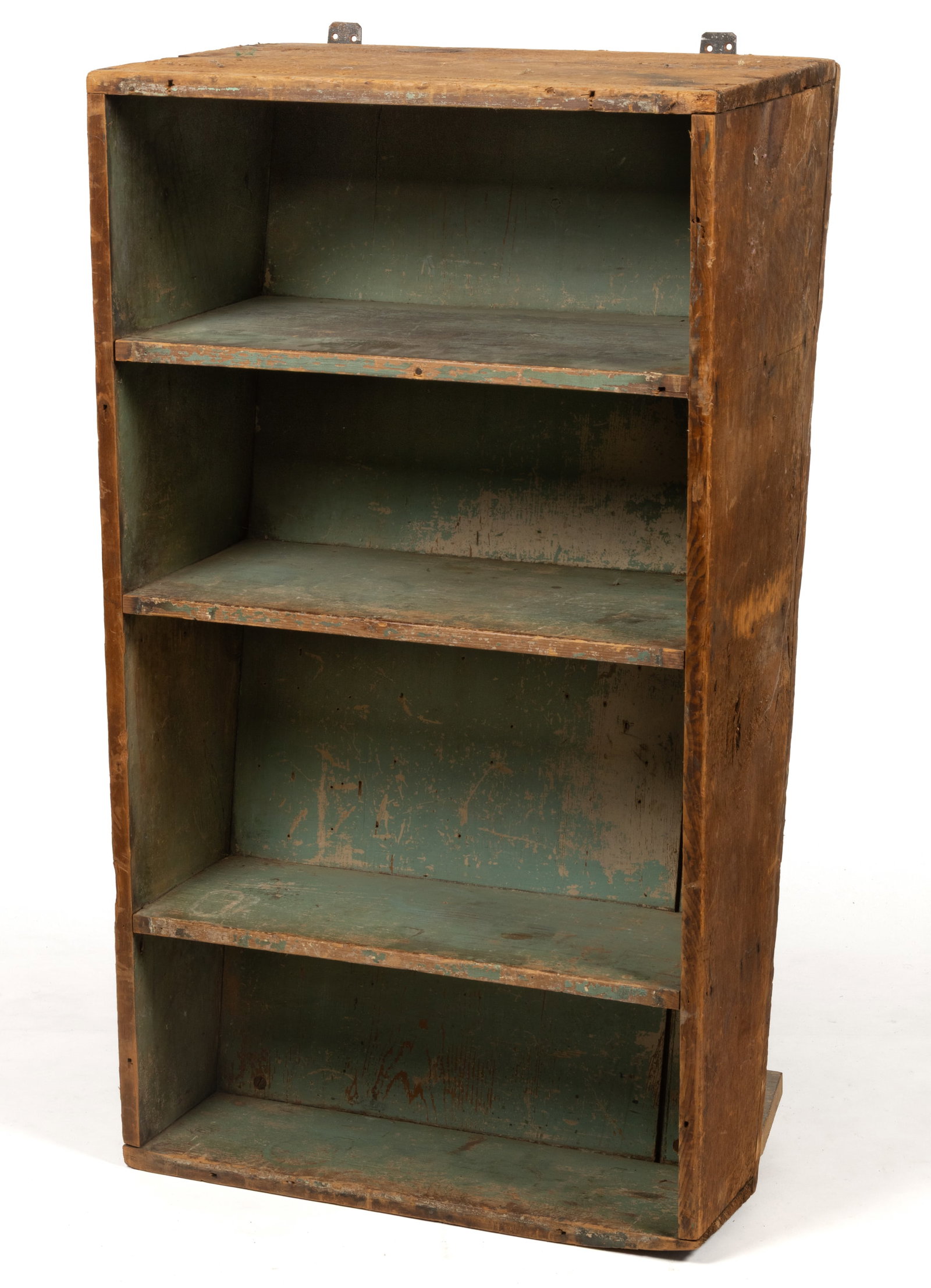 AMERICAN PAINTED PINE HANGING SHELF: AMERICAN PAINTED PINE HANGING SHELF, nailed construction, rectangular form with a steeply-canted back and three fixed shelves. Retaining an early green painted surface. A later-added board at the back