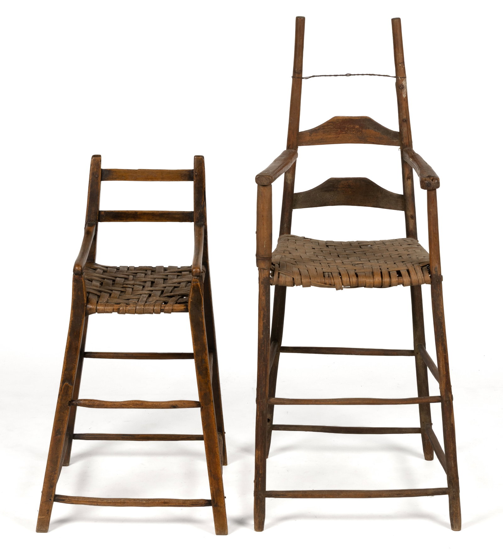 AMERICAN LADDER-BACK CHILD'S HIGHCHAIRS, LOT OF TWO: AMERICAN LADDER-BACK CHILD'S HIGHCHAIRS, LOT OF TWO, each of a similar form, comprising a two-slat (formerly three) taller example with a number of charming make-do repairs, having carved arms, a