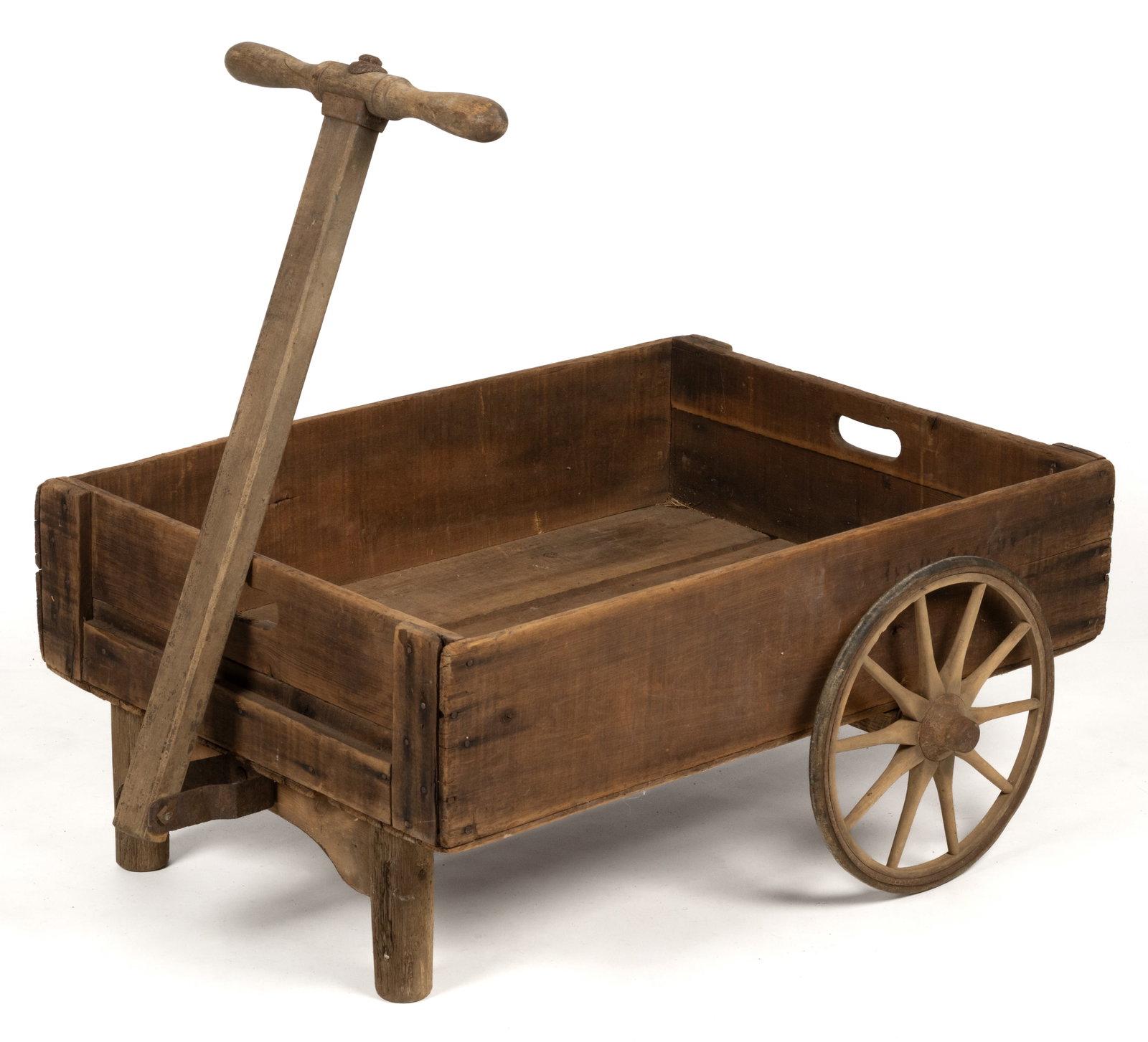 COUNTRY WOODEN PULL WAGON: COUNTRY WOODEN PULL WAGON, assembled from old parts, retaining a dry, natural surface. 20th century. 28" HOA (including handle upright), 35" LOA, 23" WOA. Provenance: The estate
